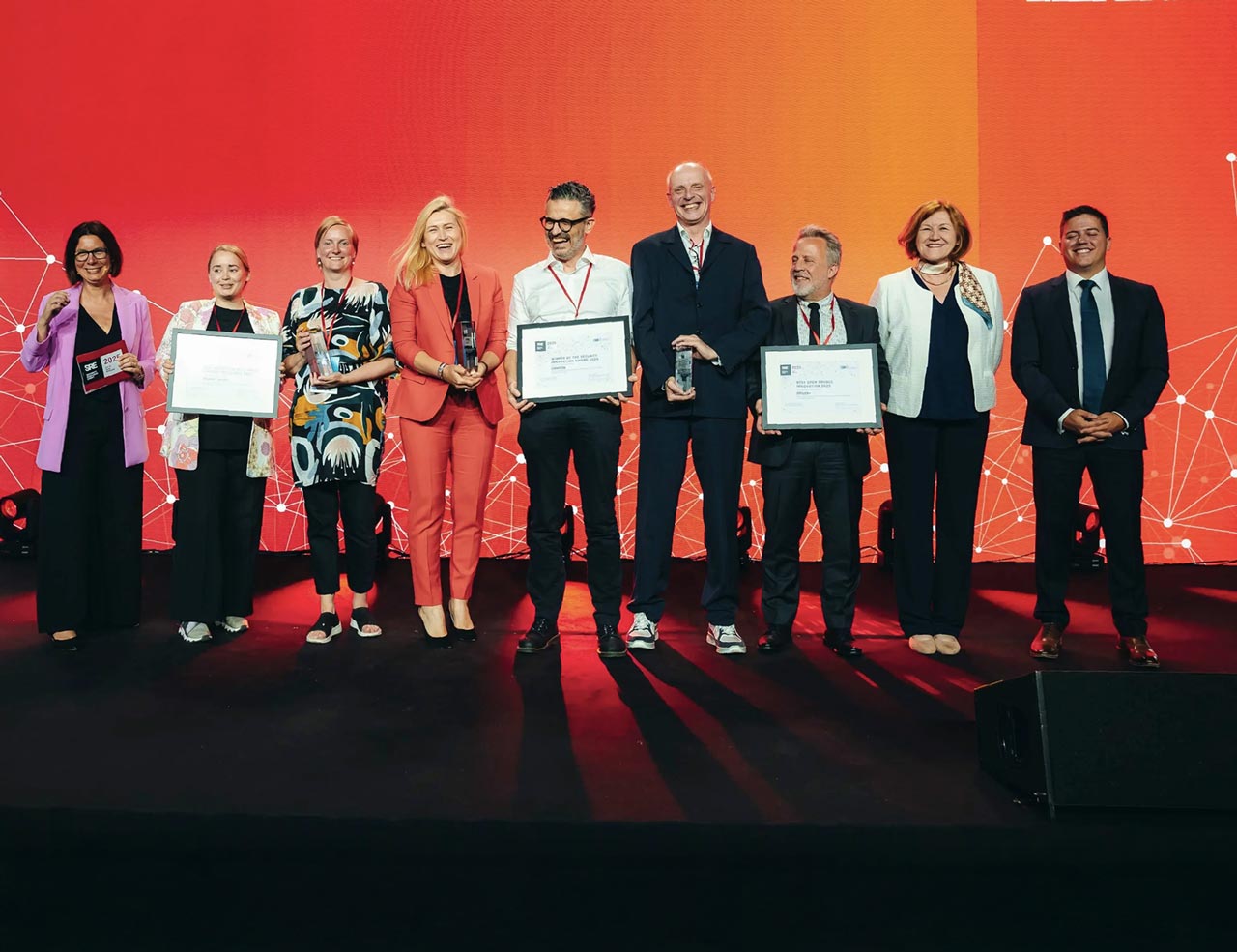 People standing on stage holding an award